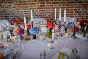 centre de table d'honneur mariage bohême gypsy coloré, vieille vaisselle et bougeoirs dorés